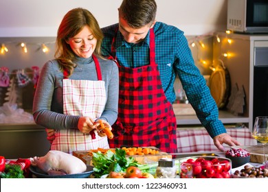 Couple Celebrating Christmas In The Kitchen Cooking Christmas Duck Or Goose