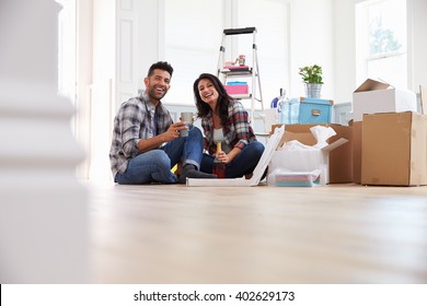 Couple Celebrating Moving Into New Home With Champagne