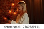 Couple celebrating valentines day and having a romantic dinner in restaurant, woman holding red roses, happy smiling expression, close up.