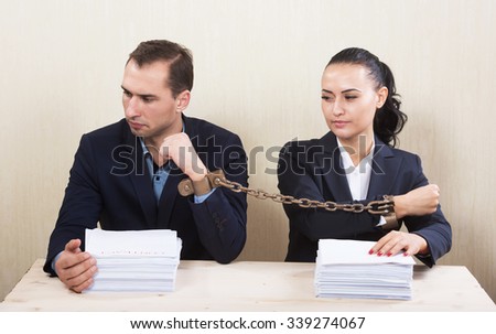 Couple with chained hands reading a contract, concept Stockfoto © 