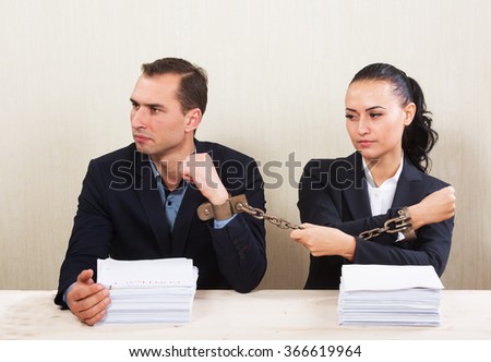Couple with chained hands reading a contract, concept Stockfoto © 
