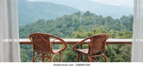 Couple chairs on balcony of countryside home or homestay with mountain view background in the morning