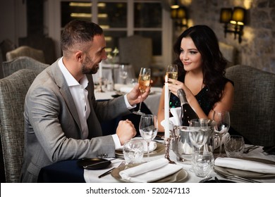 Couple With Champange Glasses Dating And Toasting In Restaurant