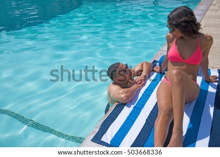 Couple chatting beside pool