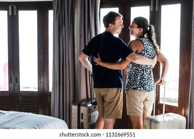 Couple Checking In To A Hotel Room