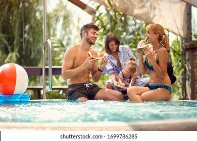 Couple With Child And Babysitter Eats Water Melon On Pool