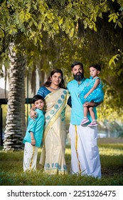 couple with children onam dress saree and lungi - Shutterstock ID 2251326475