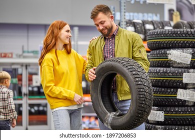 Couple Choose Tire For Their First Car In The Store, Discuss, Have Talk In The Shop, Wearing Casual Clothes