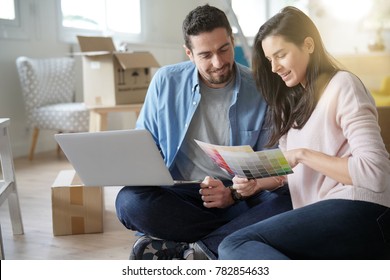 Couple Choosing Paint Colours To Reform House