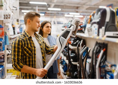 Couple Choosing Vacuum Cleaner, Electronics Store