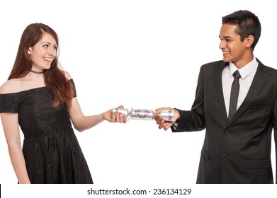 Couple With Christmas Cracker Having Fun. Isolated In Studio On White Background.