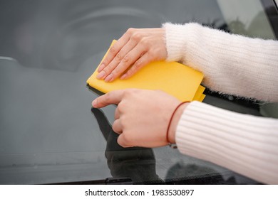 Couple Cleaning Car Windshield With Rag Close Up