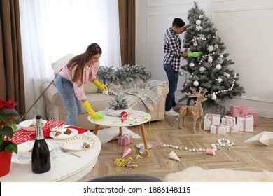 Couple Cleaning Messy Room After New Year Party