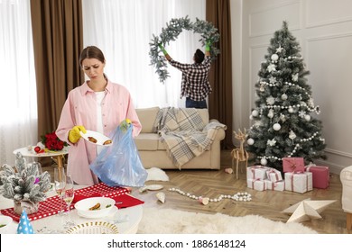 Couple Cleaning Messy Room After New Year Party