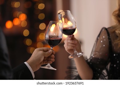 Couple clinking glasses at Valentine's day dinner in restaurant, closeup - Shutterstock ID 1923637691