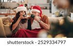 Couple, coffee and sofa in home for Christmas, celebration and bonding together with holiday and hug. Woman, man and mature people in living room for relax, support and vacation with embrace in house