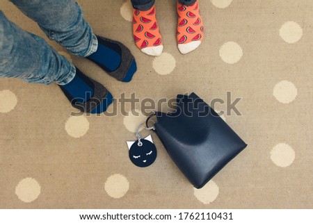 
couple in colorful socks and bag on the floor