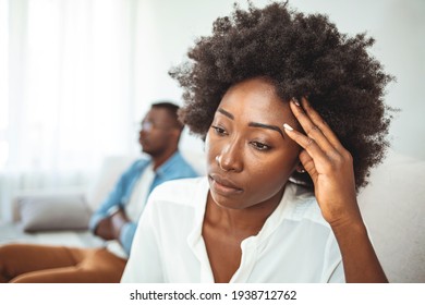 Couple conflict. Stressed crying female sitting on couch with abusive husband after quarrel, ready to divorce. Offended millennial couple avoid talking after fight. 