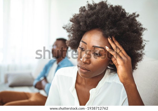 Couple conflict. Stressed\
crying female sitting on couch with abusive husband after quarrel,\
ready to divorce. Offended millennial couple avoid talking after\
fight. 
