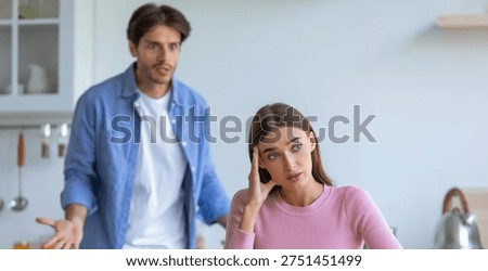 Couple in Conflict While Discussing Issues in a Kitchen During a Sunny Afternoon