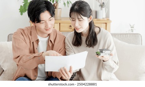 A couple considering the layout of their house - Powered by Shutterstock