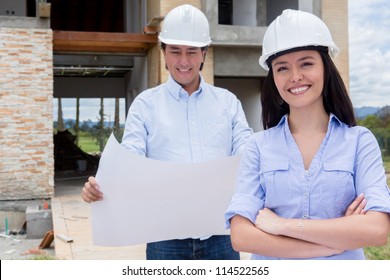 Couple At The Construction Site Of Their New Home