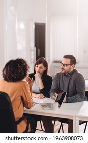 Couple Consulting With A Female Financial Manager At The Bank