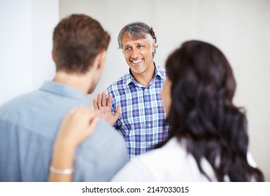 Couple Consulting Male Architect. Mature Engineer Discussing Home Renovation Plan With Couple.