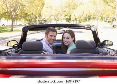 Couple In Convertible Car Smiling