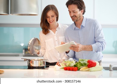 Couple Cooking Dinner At Kitchen