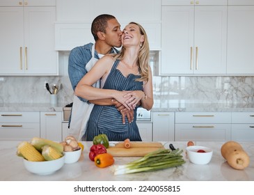 Couple, cooking food and love of vegetables with a kiss on the cheek while helping with dinner at home. Man and woman in Uk with a healthy lifestyle, diet and vegan eating for health and wellness - Powered by Shutterstock