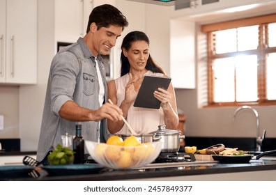 Couple, cooking and tablet for recipe, kitchen and home with online, cheerful and making dinner. Food, digital and together with internet, family and nutrition while streaming, social media and learn - Powered by Shutterstock