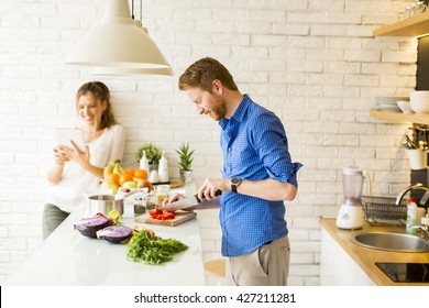 Couple Cooking Together In The Kitchen At Home