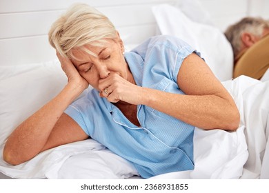 Couple, coughing or sick old woman in bed with husband or man with flu virus, tuberculosis or health problem. Chest pain, mature lady or senior person with cold, fever or lung illness in home bedroom - Powered by Shutterstock