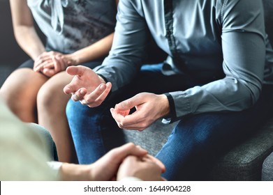 Couple counseling or therapy session. Man talking about problems in the family. Husband and wife meeting their psychiatrist. Discussion with marriage counselor, mediator or relationship psychologist.