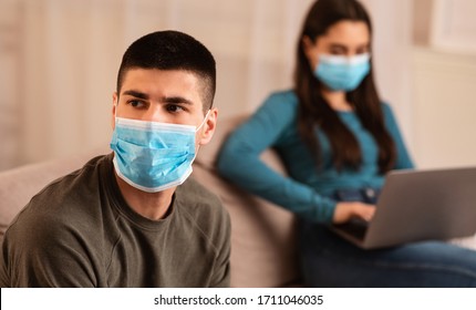 Couple Crisis During Quarantine Concept. Wife Using Laptop, Working From Home, Not Paying Attention To Husband