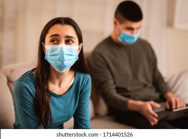 Couple Crisis During Quarantine Concept. Man Using Laptop, Working From Home, Not Paying Attention To Wife