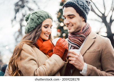 Couple with cups of mulled wine on Christmas market - Powered by Shutterstock