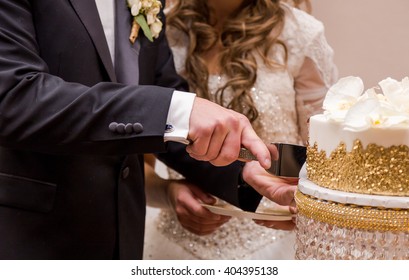 Couple Cutting Their Wedding Cake.