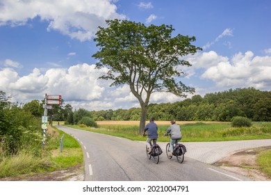 Couple Cycling In The Nature Reserve Of Balloerveld In Drenthe, Netherlands