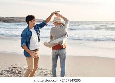 Couple, dancing and happy together on beach, seaside and holiday for relationship bonding and love or affection. Ocean, calm and fun with partners on vacation trip, relax and movement for joy on date - Powered by Shutterstock