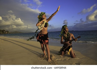 couple dancing hula on the beach at sunrise with the man playing ukulele - Powered by Shutterstock