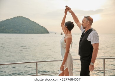 couple dancing on luxury yacht at the sea - Powered by Shutterstock