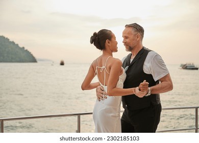 couple dancing on luxury yacht at the sea - Powered by Shutterstock