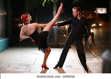 Couple Dancing On A Street At Night.