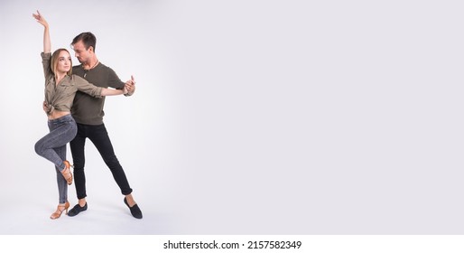 Couple dancing social dance. Kizomba bachata or semba salsa or taraxia on white background with copy space banner and place for text - Social dance concept. - Shutterstock ID 2157582349