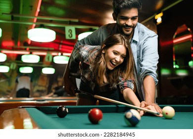 Couple dating, flirting and playing billiard in a pub - Shutterstock ID 2282184945