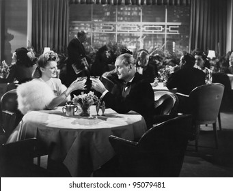 Couple dining in crowded restaurant