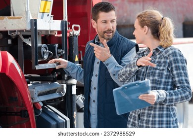 couple discussing over clipboard in farm - Powered by Shutterstock