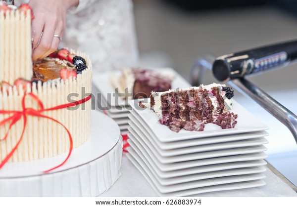 The couple\
divided into shares of a wedding\
cake.